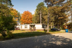Whispering Pines Aspire Communities Home with Autumn Colored Trees