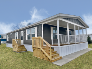 Modern Michigan modular home with a covered porch and wooden steps.